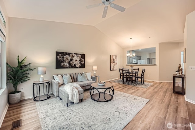 4313 S 220th Pl Unit 18-2, Kent, WA 98032 - living area featuring light wood-style flooring, lofted ceiling, a chandelier, ceiling fan, and baseboards
