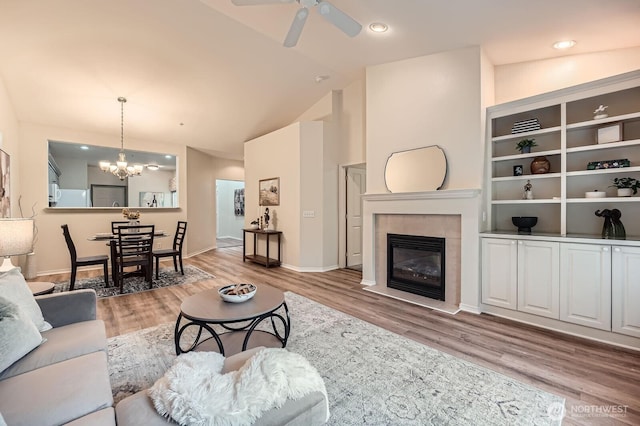 4313 S 220th Pl Unit 18-2, Kent, WA 98032 - living area featuring vaulted ceiling, a chandelier, a fireplace, light wood-style flooring, and ceiling fan
