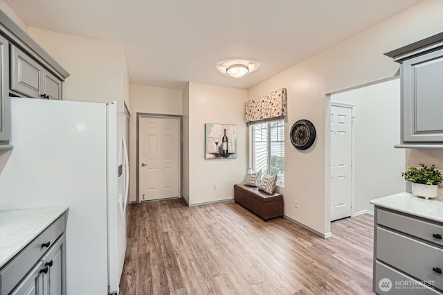4313 S 220th Pl Unit 18-2, Kent, WA 98032 - kitchen with freestanding refrigerator, gray cabinetry, light wood-style floors, and light countertops