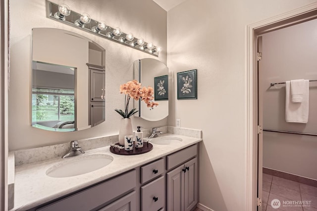 4313 S 220th Pl Unit 18-2, Kent, WA 98032 - bathroom with double vanity, tile patterned floors, and baseboards
