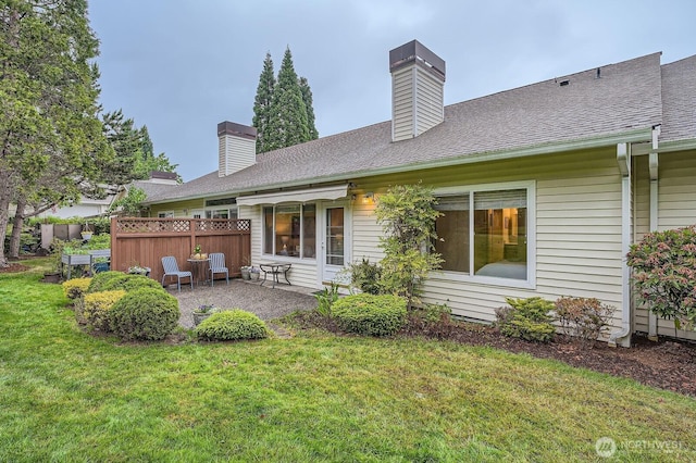 4313 S 220th Pl Unit 18-2, Kent, WA 98032 - rear view of property with a chimney, a patio, and roof with shingles