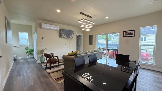 9025 38th Ave S, Seattle, WA 98118 - dining area with a wall unit AC, dark wood-style floors, baseboards, recessed lighting, and a chandelier