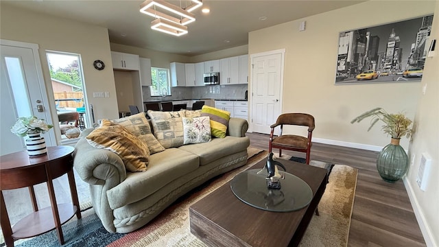 9025 38th Ave S, Seattle, WA 98118 - living area featuring baseboards, dark wood-type flooring, and a chandelier