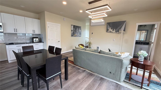 9025 38th Ave S, Seattle, WA 98118 - dining space featuring dark wood-type flooring, recessed lighting, a wall mounted air conditioner, baseboards, and a chandelier