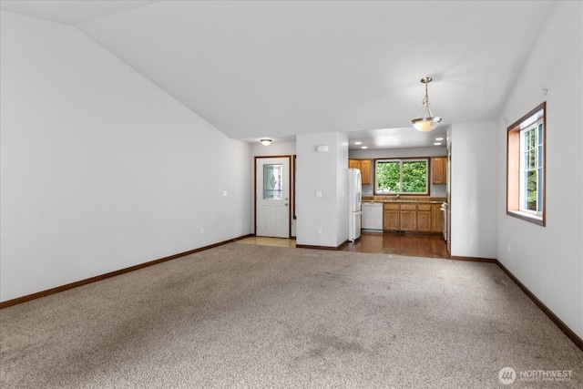 2323 Baird Ave, Snohomish, WA 98290 - unfurnished living room with carpet floors, vaulted ceiling, and baseboards