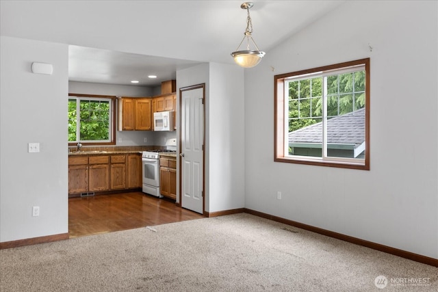 2323 Baird Ave, Snohomish, WA 98290 - kitchen with white appliances, dark carpet, baseboards, a sink, and brown cabinetry
