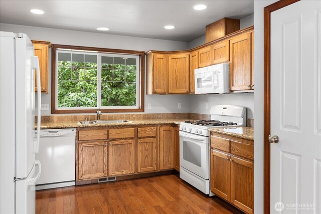 2323 Baird Ave, Snohomish, WA 98290 - kitchen featuring white appliances, a sink, recessed lighting, dark wood-style floors, and brown cabinets