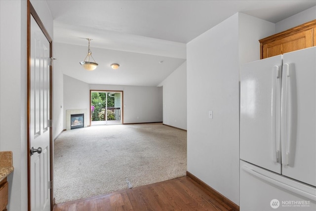 2323 Baird Ave, Snohomish, WA 98290 - unfurnished living room with wood finished floors, baseboards, a fireplace, and carpet floors