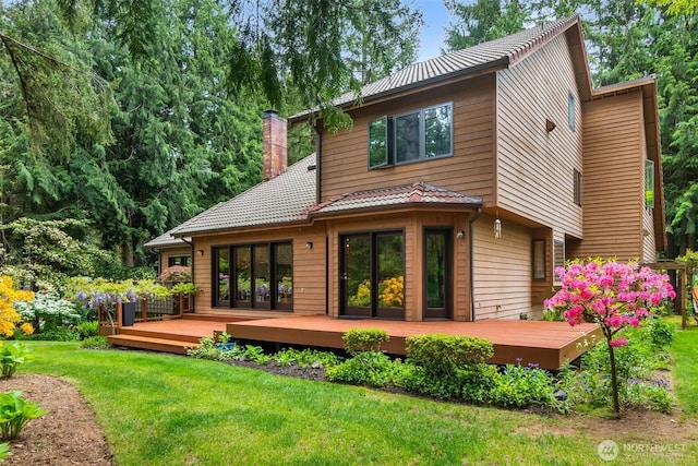6206 SW Tiger Tail Dr, Olympia, WA 98512 - rear view of house with a chimney, a wooden deck, a yard, and a tiled roof