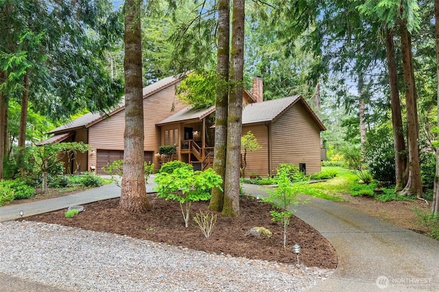 6206 SW Tiger Tail Dr, Olympia, WA 98512 - mid-century inspired home with driveway, an attached garage, and a chimney