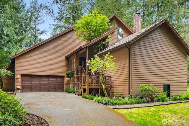 6206 SW Tiger Tail Dr, Olympia, WA 98512 - view of front of property featuring a chimney, driveway, a tiled roof, and a garage