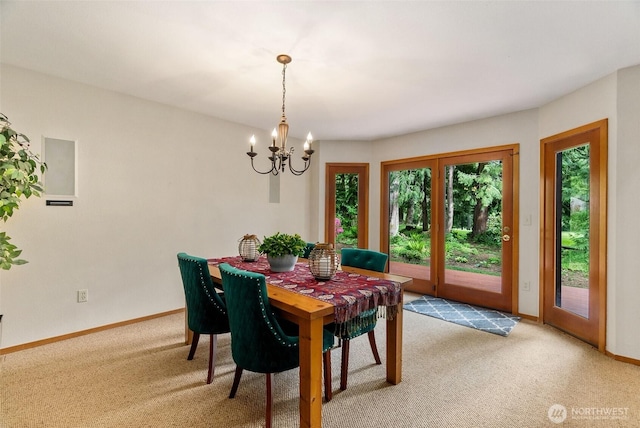 6206 SW Tiger Tail Dr, Olympia, WA 98512 - dining area with light carpet, a chandelier, and baseboards