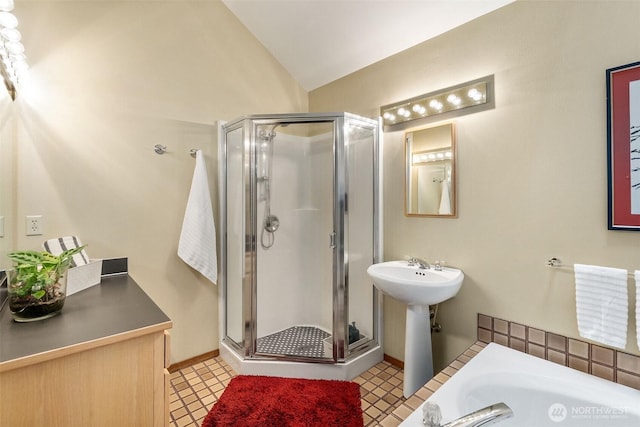 6206 SW Tiger Tail Dr, Olympia, WA 98512 - bathroom featuring a shower stall, lofted ceiling, a bathtub, a sink, and tile patterned floors