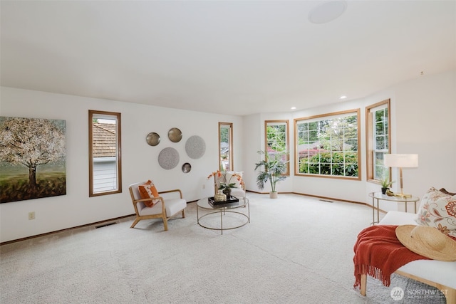sitting room with carpet, plenty of natural light, baseboards, and recessed lighting
