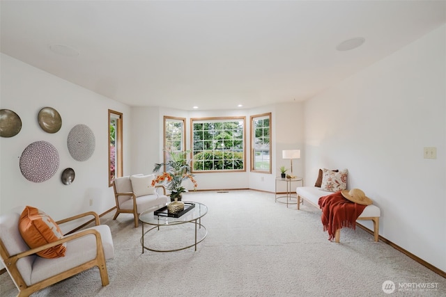 carpeted living area with baseboards