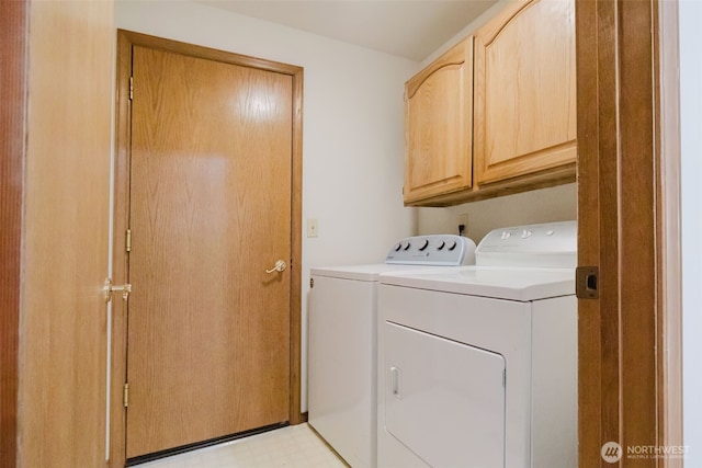 washroom with independent washer and dryer, cabinet space, and light flooring
