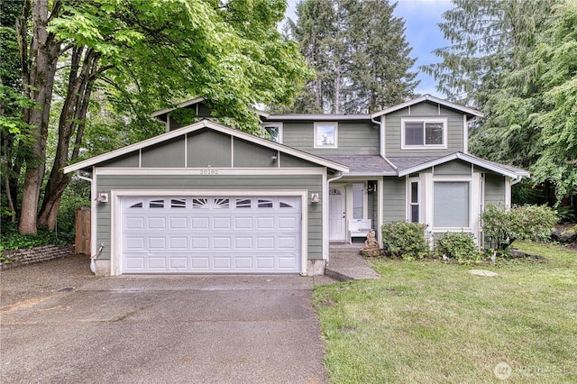 20282 NW Cedar Ln, Poulsbo, WA 98370 - traditional-style home with driveway, a garage, and a front yard