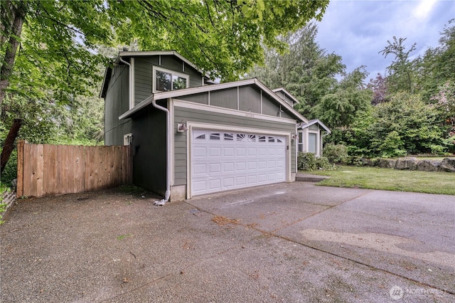 20282 NW Cedar Ln, Poulsbo, WA 98370 - view of side of property with concrete driveway and an attached garage