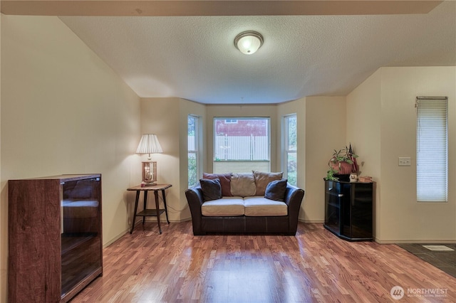20282 NW Cedar Ln, Poulsbo, WA 98370 - living room featuring wood finished floors, baseboards, and a textured ceiling