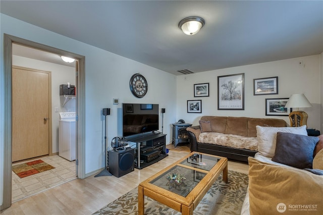 20282 NW Cedar Ln, Poulsbo, WA 98370 - living area featuring washer / clothes dryer and light wood finished floors