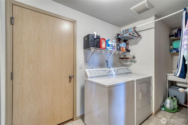 20282 NW Cedar Ln, Poulsbo, WA 98370 - washroom featuring washing machine and dryer and light tile patterned flooring