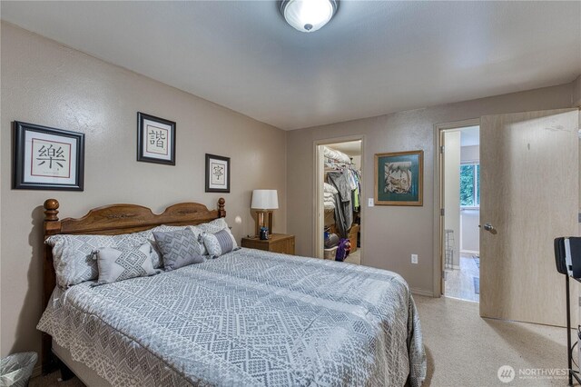 20282 NW Cedar Ln, Poulsbo, WA 98370 - bedroom with light colored carpet, a spacious closet, a closet, and baseboards