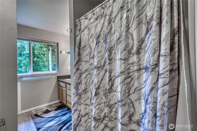 20282 NW Cedar Ln, Poulsbo, WA 98370 - full bath featuring vanity, baseboards, and a shower with curtain