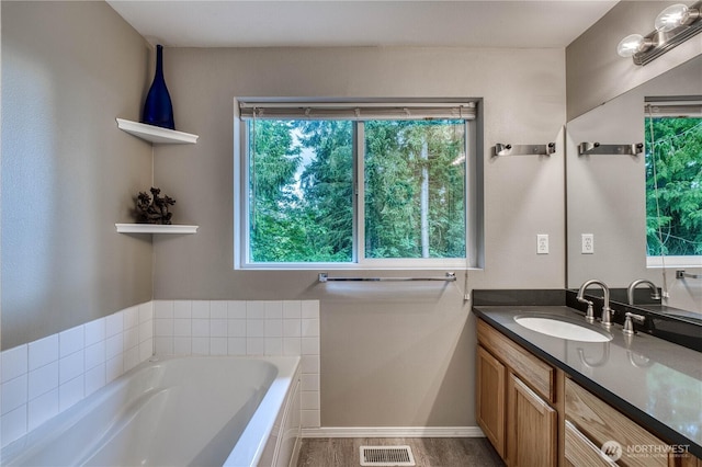 20282 NW Cedar Ln, Poulsbo, WA 98370 - full bathroom with vanity, a garden tub, and plenty of natural light