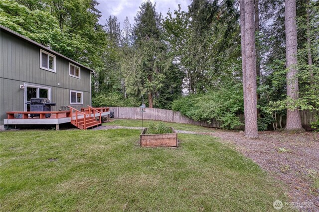 20282 NW Cedar Ln, Poulsbo, WA 98370 - view of yard with a vegetable garden and a deck