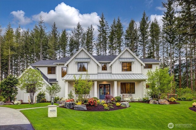 43268 SE 145th Pl, North Bend, WA 98045 - modern inspired farmhouse featuring a standing seam roof, board and batten siding, covered porch, a front lawn, and metal roof