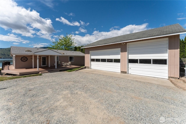 34 Leisure Ln, Manson, WA 98831 - view of front of home featuring a detached garage, a wooden deck, and an outbuilding