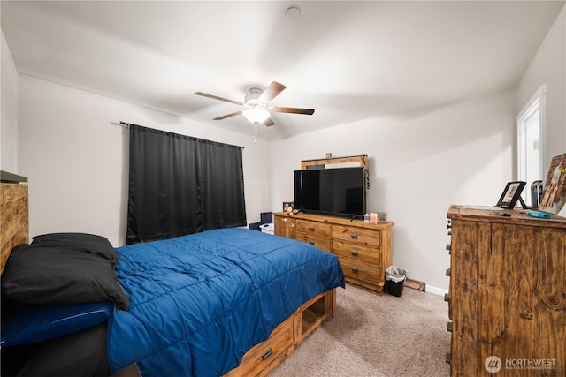 carpeted bedroom with ceiling fan and baseboards