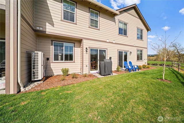 back of property featuring a lawn