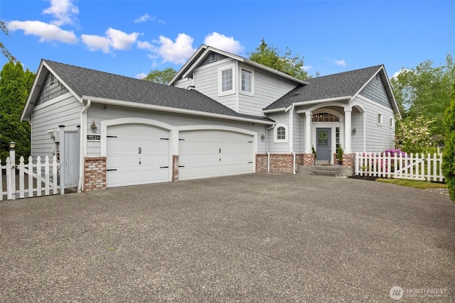 7521 Sterling Pl, Arlington, WA 98223 - view of front of property featuring an attached garage, concrete driveway, brick siding, and roof with shingles