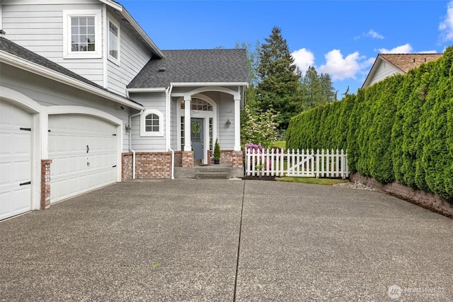 7521 Sterling Pl, Arlington, WA 98223 - view of side of property with brick siding, driveway, roof with shingles, and an attached garage