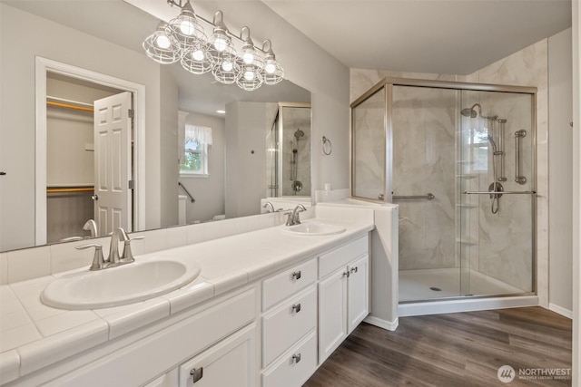7521 Sterling Pl, Arlington, WA 98223 - bathroom featuring a shower stall, double vanity, and wood finished floors
