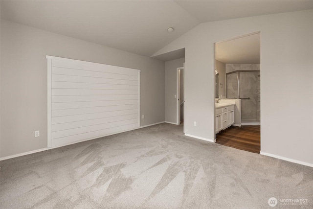 7521 Sterling Pl, Arlington, WA 98223 - unfurnished bedroom with carpet floors, vaulted ceiling, ensuite bath, and baseboards