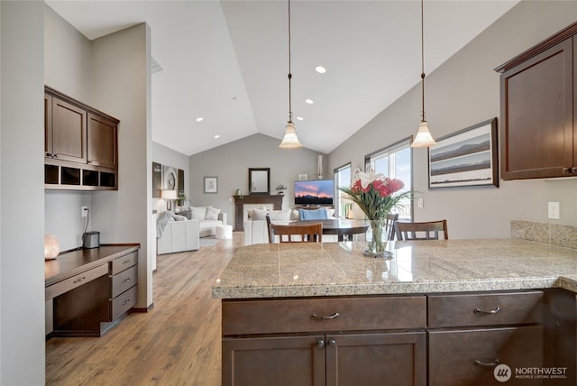 kitchen with tile countertops, dark brown cabinets, lofted ceiling, wood finished floors, and hanging light fixtures