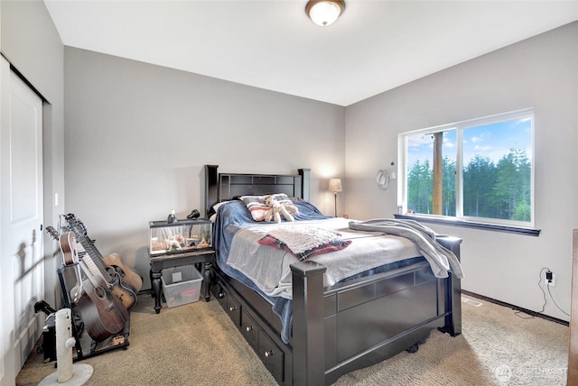 bedroom with light carpet and baseboards