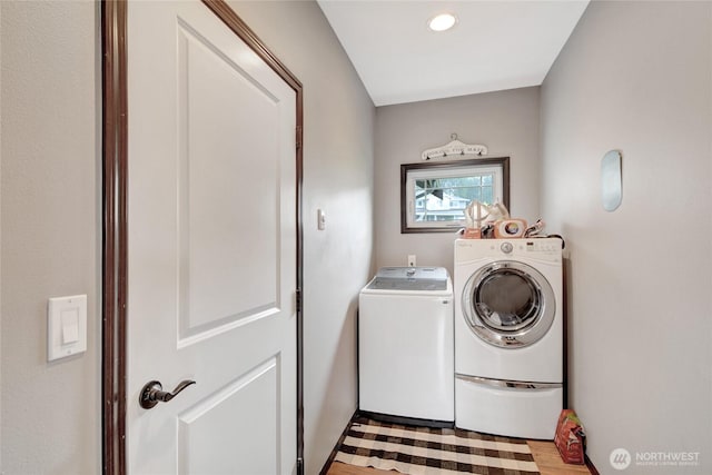 clothes washing area with washer and clothes dryer, light wood-type flooring, and recessed lighting