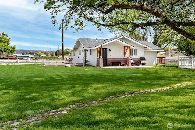 21 Hexon Rd, Selah, WA 98942 - view of property exterior featuring brick siding, a patio area, roof with shingles, and board and batten siding