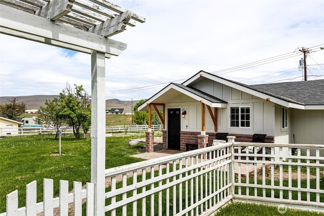 21 Hexon Rd, Selah, WA 98942 - view of front of house with a mountain view, a pergola, board and batten siding, and a shingled roof