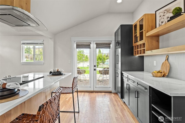 21 Hexon Rd, Selah, WA 98942 - kitchen with open shelves, vaulted ceiling, light stone counters, backsplash, and light wood-style flooring