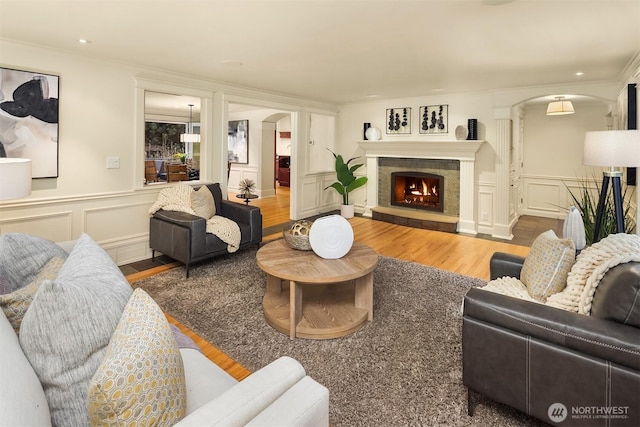 2249 78th Ave SE, Mercer Island, WA 98040 - living area with a decorative wall, arched walkways, wood finished floors, ornamental molding, and a fireplace