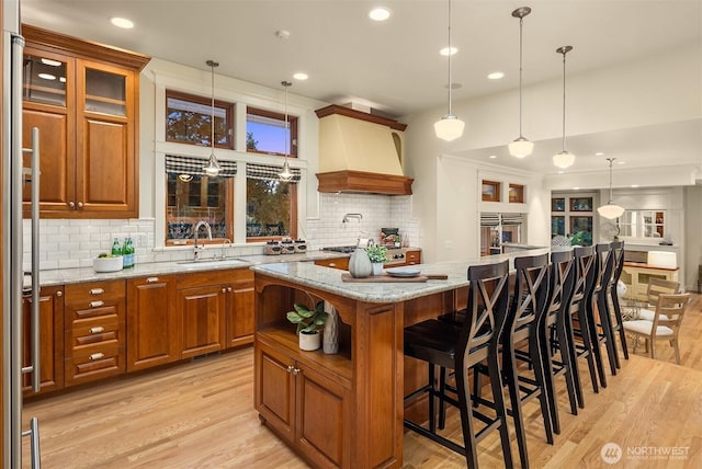 2249 78th Ave SE, Mercer Island, WA 98040 - kitchen featuring a sink, custom range hood, brown cabinets, light wood finished floors, and recessed lighting