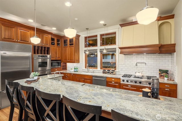 2249 78th Ave SE, Mercer Island, WA 98040 - kitchen with built in appliances, brown cabinets, a sink, a kitchen breakfast bar, and recessed lighting