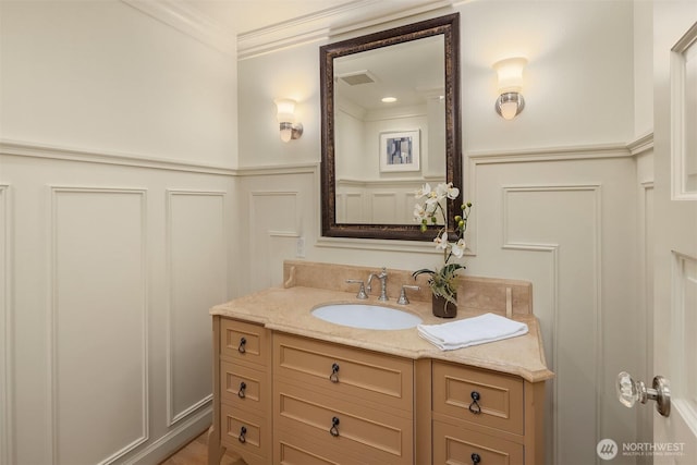 2249 78th Ave SE, Mercer Island, WA 98040 - bathroom featuring a decorative wall, vanity, wainscoting, and ornamental molding
