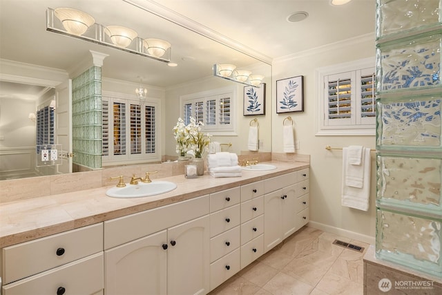 2249 78th Ave SE, Mercer Island, WA 98040 - bathroom featuring crown molding, double vanity, marble look tiles, and baseboards