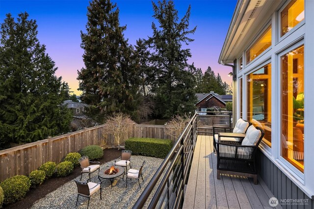 2249 78th Ave SE, Mercer Island, WA 98040 - deck at dusk featuring an outdoor fire pit and a fenced backyard
