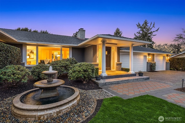 2249 78th Ave SE, Mercer Island, WA 98040 - view of front facade featuring a chimney, a garage, and driveway